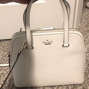 White gentle used Kate spade purse with detachable cross body strap.